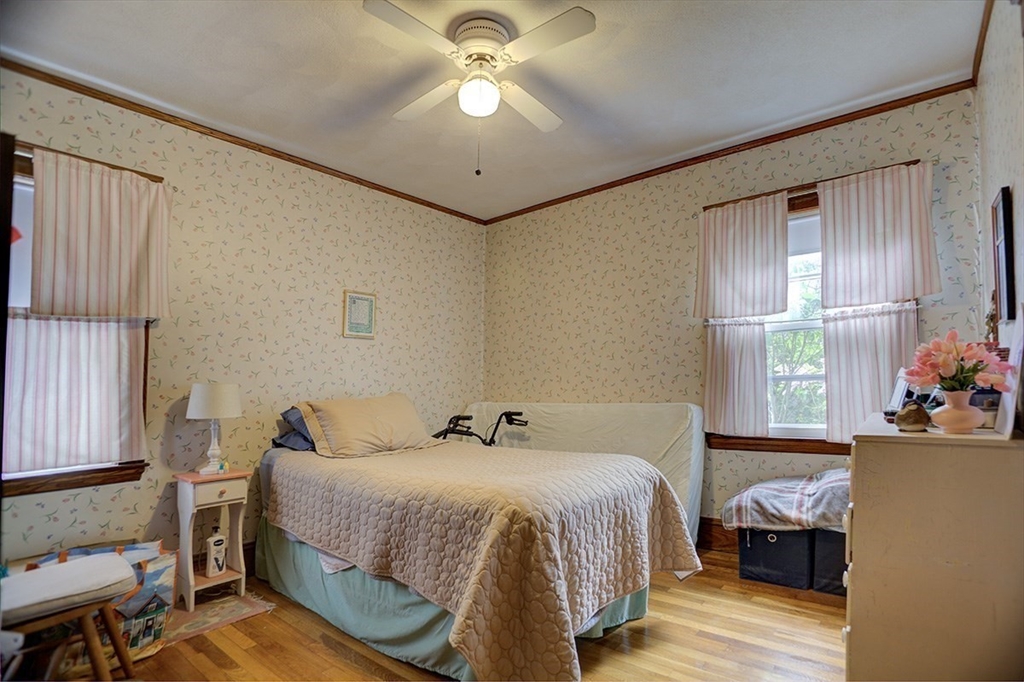 44 Cottage Park Road Winthrop, MA 02152 - Photo 30 of 39 a bedroom with a bed and a chandelier
