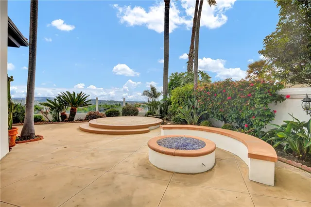 a view of a swimming pool with a patio and plants