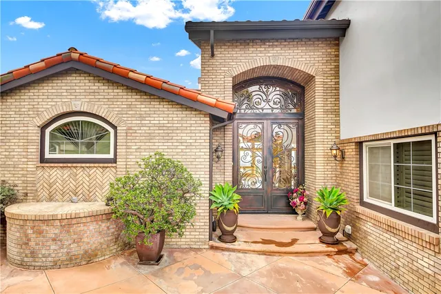a view of a house with potted plants