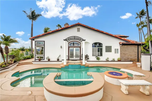 a front view of a house with swimming pool having outdoor seating