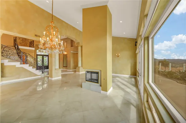 a large kitchen with kitchen island a stove a sink a refrigerator and white cabinets