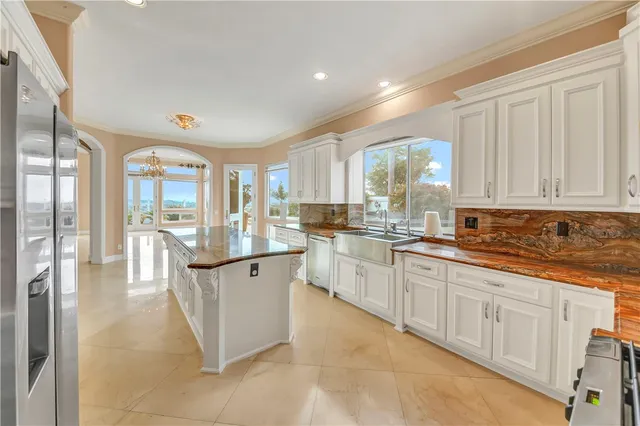 a spacious bedroom with a large bed and a large window with the outer view