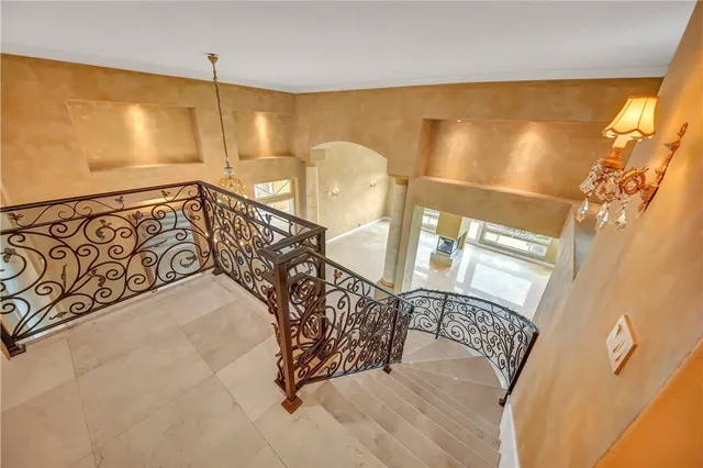 a view of a hallway with wooden floor and a window