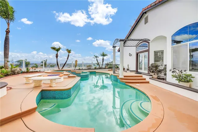 a view of a swimming pool with an outdoor seating