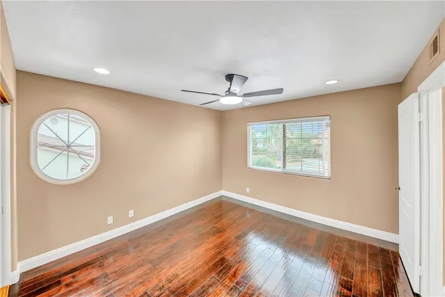 an aerial view of residential houses with outdoor space and trees