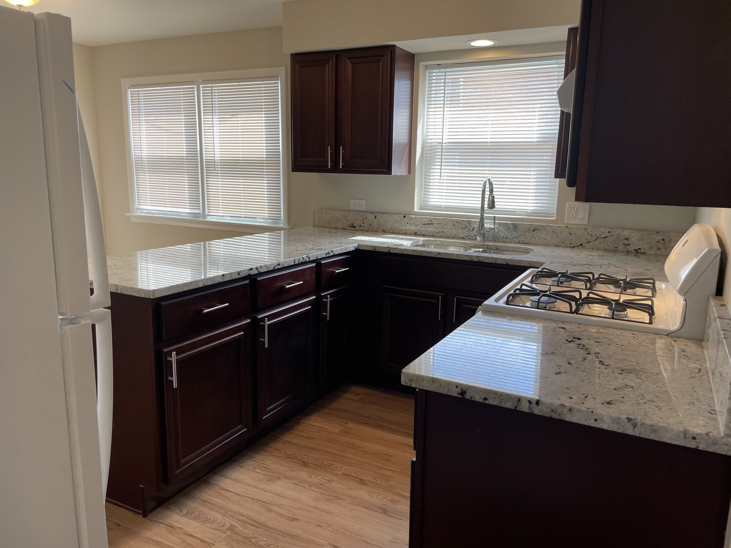 7541 Roberts Road, Unit 1 Bridgeview, IL 60455 - Photo 2 of 10 a kitchen with a sink stove and cabinets
