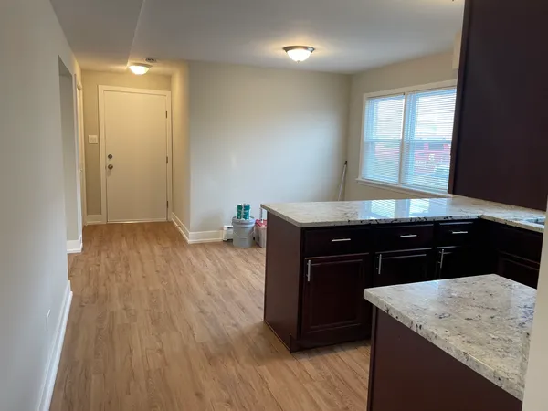 a kitchen with a wooden floor and a sink