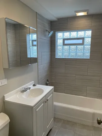 a bathroom with a sink a toilet and a bathtub