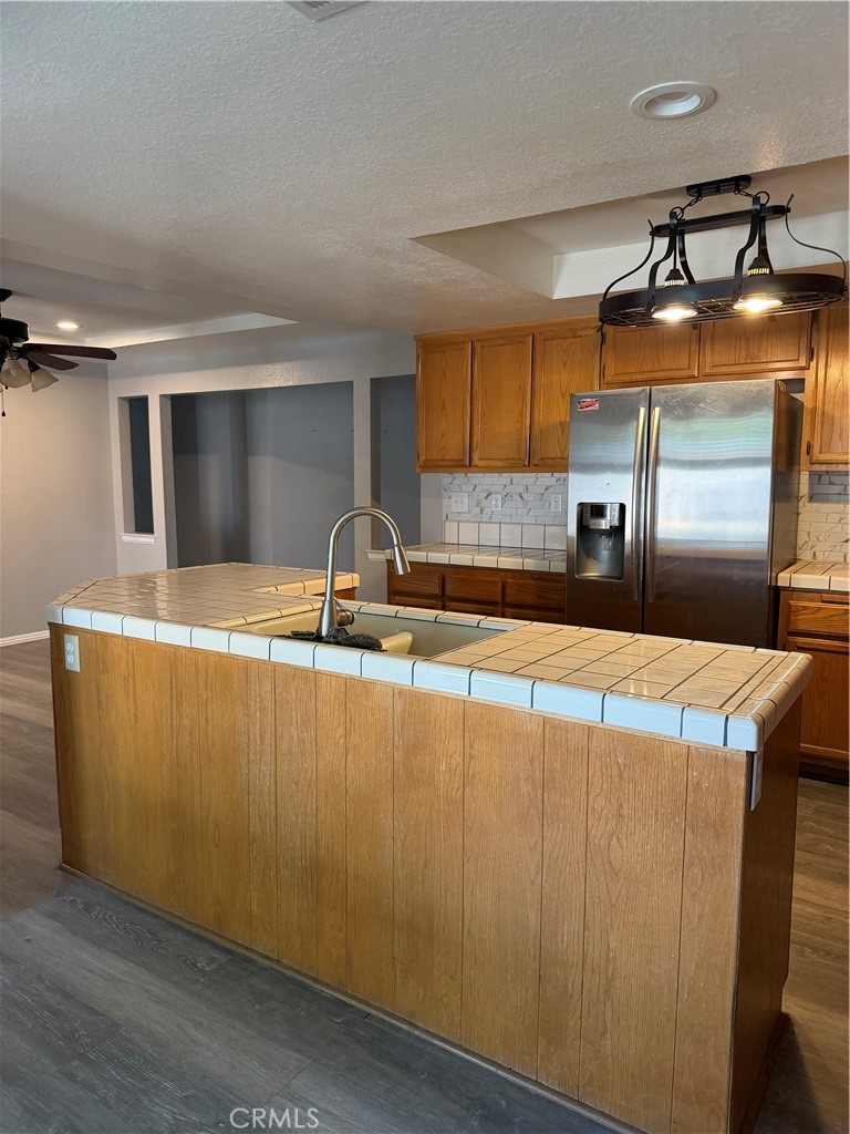 18602 Cocqui Road Apple Valley, CA 92307 - Photo 13 of 16 a room with kitchen island a sink and wooden floor