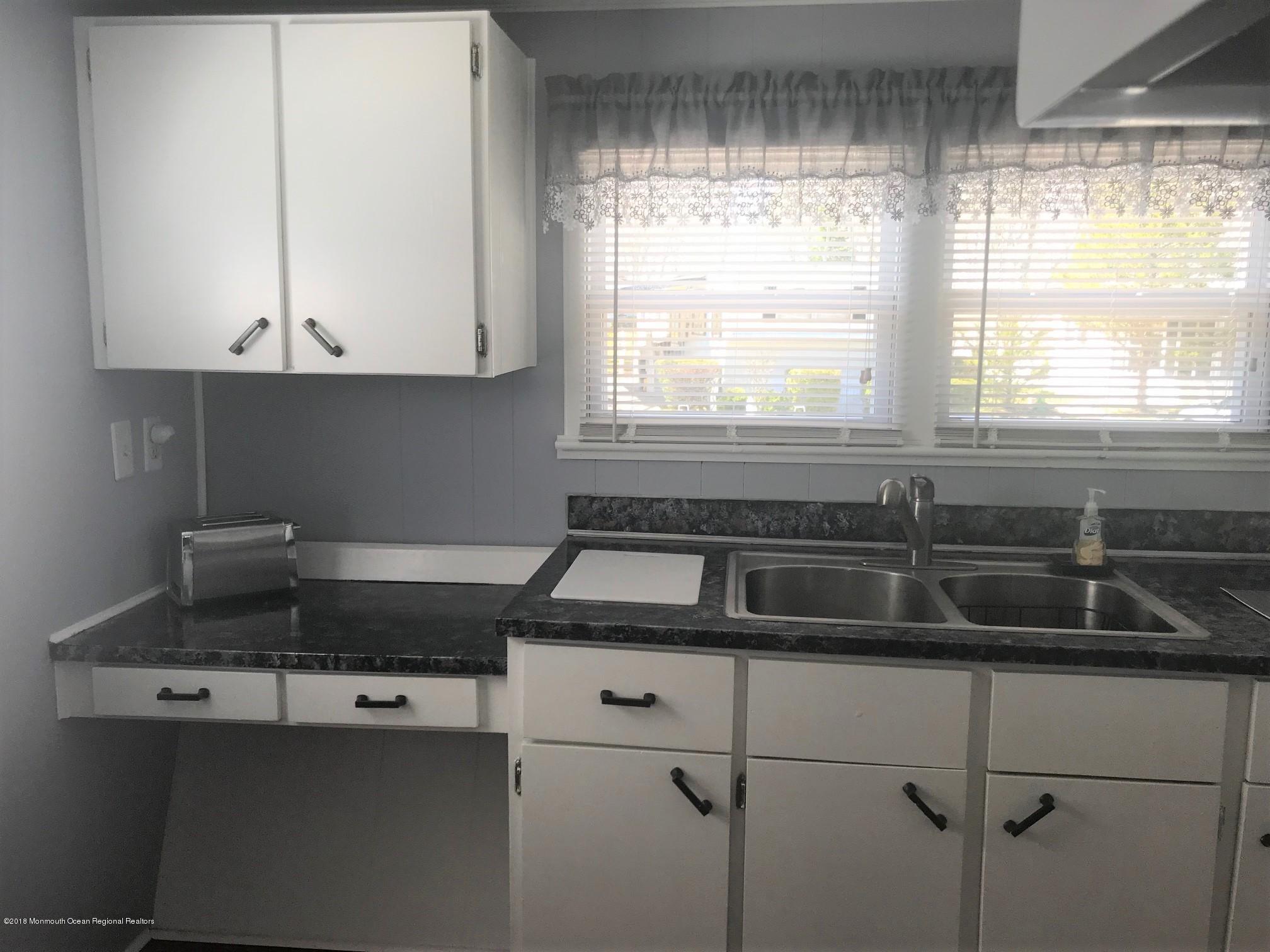 65 Roberts Road Toms River, NJ 08755 - Photo 4 of 24 a kitchen with a sink a window and cabinets