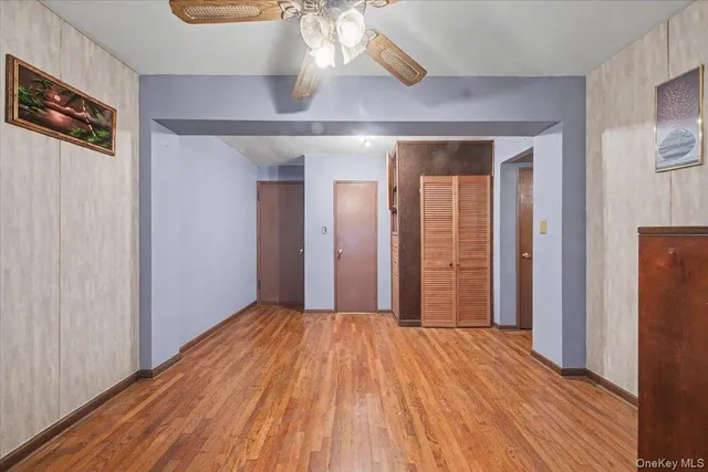 a view of a room with wooden floor