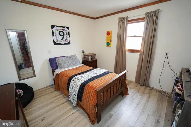 a bedroom with furniture and wooden floor