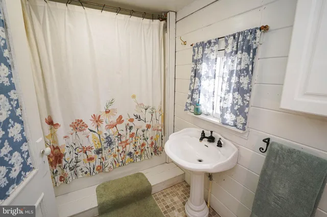 a bathroom with a sink toilet and mirror