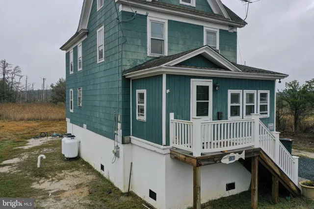 a view of a house with wooden fence