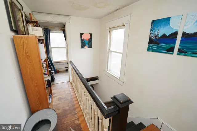 a view of a hallway with windows and stairs