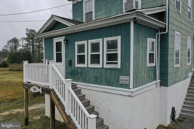 a living room with furniture a flat screen tv and a window