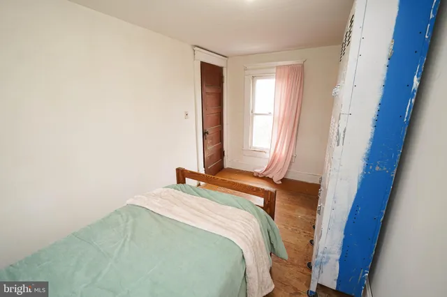 a bedroom with bed and a window