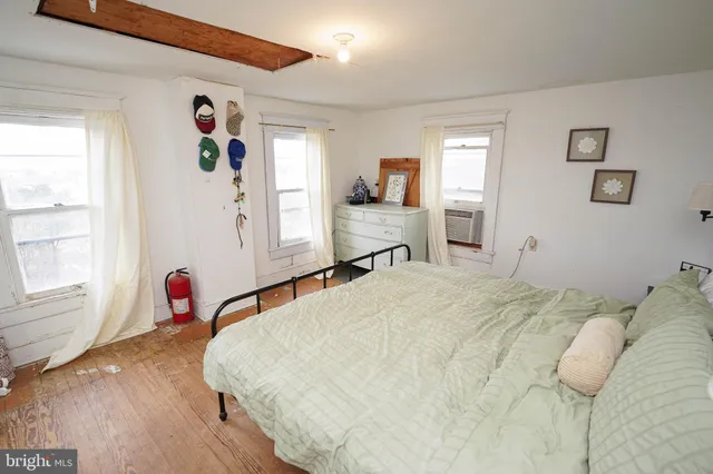 a spacious bedroom with a bed and a window