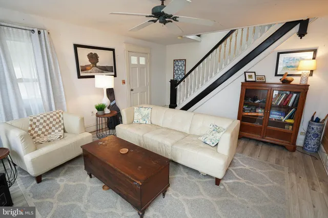 a kitchen with stainless steel appliances granite countertop a kitchen island hardwood floor and a sink