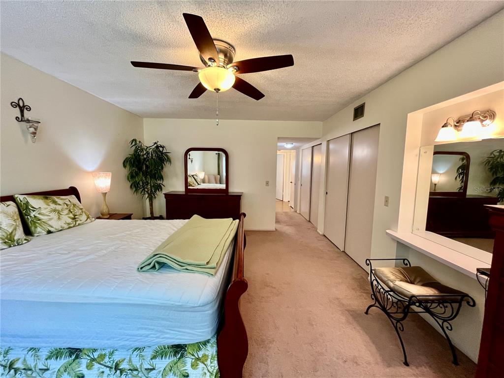 2292 Costa Rican Drive, Unit 22 Clearwater, FL 33763 - Photo 17 of 44 a bedroom with a bed and a large mirror