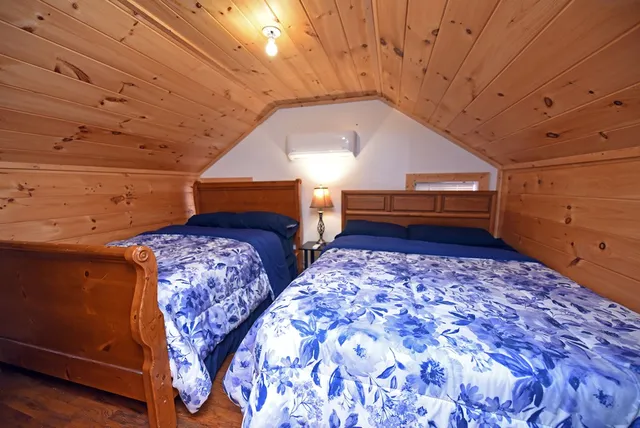 a bedroom with bed and a window