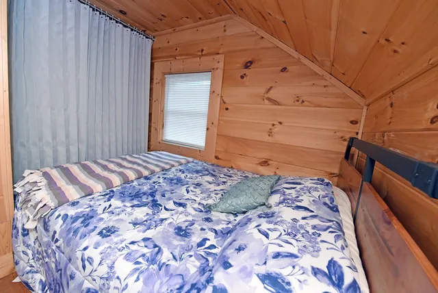 a bedroom with a bed and a mirror