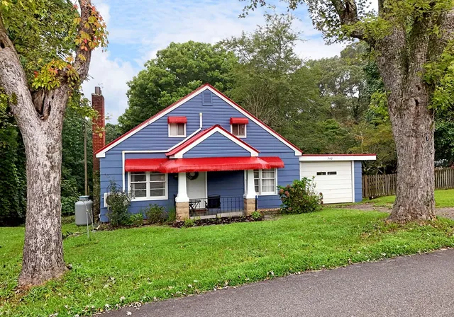 a front view of house with yard and green space