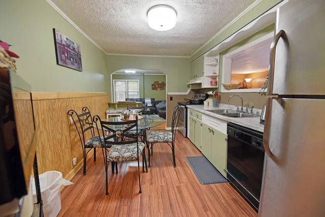 a balcony with wooden floor in front of house