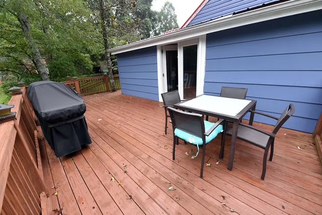 a balcony with wooden floor and outdoor space