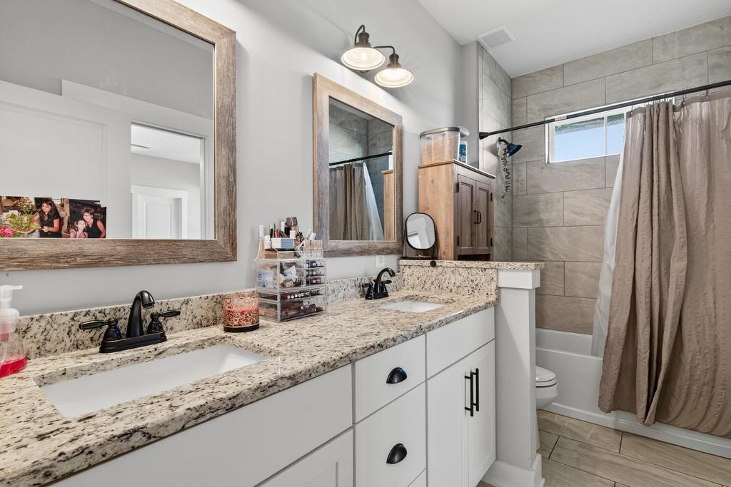 75774 Edwards Road Yulee, FL 32097 - Photo 35 of 70 a bathroom with a granite countertop sink toilet and shower