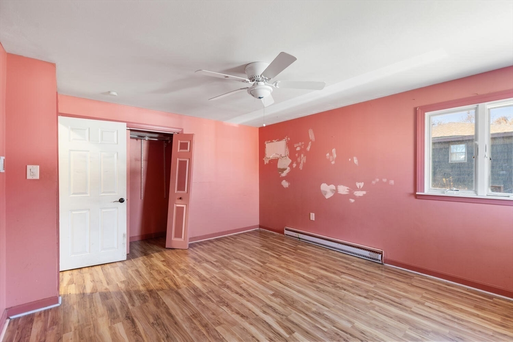 38 Valley Street Salem, MA 01970 - Photo 17 of 32 a view of an empty room with window and wooden floor