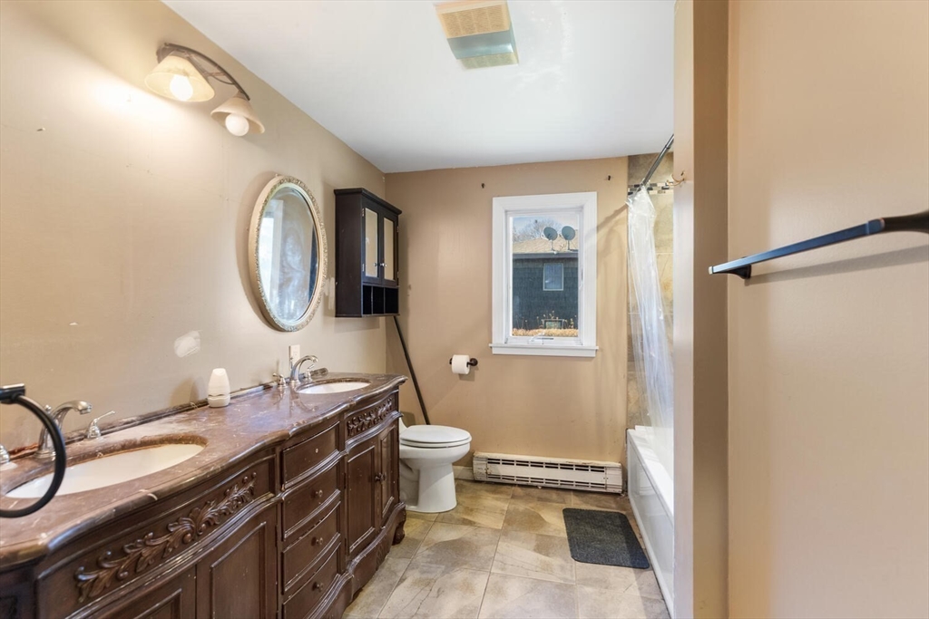 38 Valley Street Salem, MA 01970 - Photo 18 of 32 a bathroom with a double vanity sink mirror and toilet