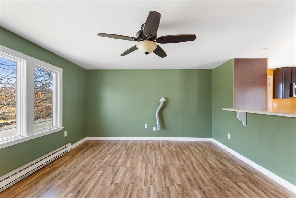 38 Valley Street Salem, MA 01970 - Photo 8 of 32 a view of a room with a ceiling fan and a window