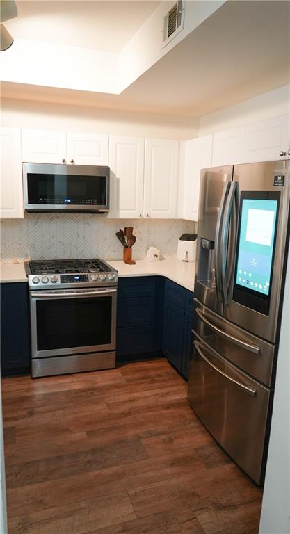 3275 Lenox Road Northeast, Unit 107 Atlanta, GA 30324 - Photo 3 of 18 a kitchen with stainless steel appliances and view of wooden cabinets