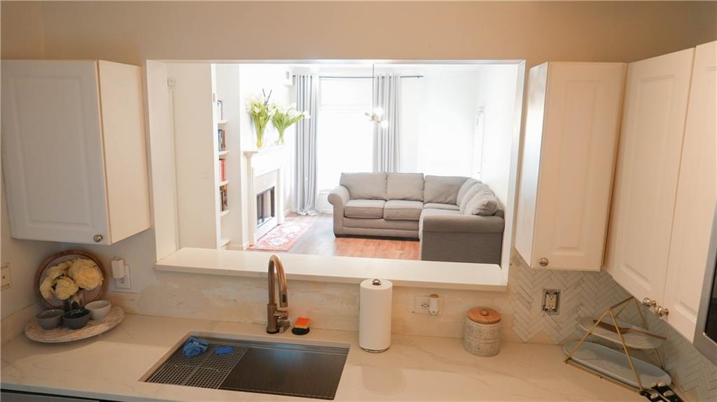 3275 Lenox Road Northeast, Unit 107 Atlanta, GA 30324 - Photo 6 of 18 a living room with furniture and a window