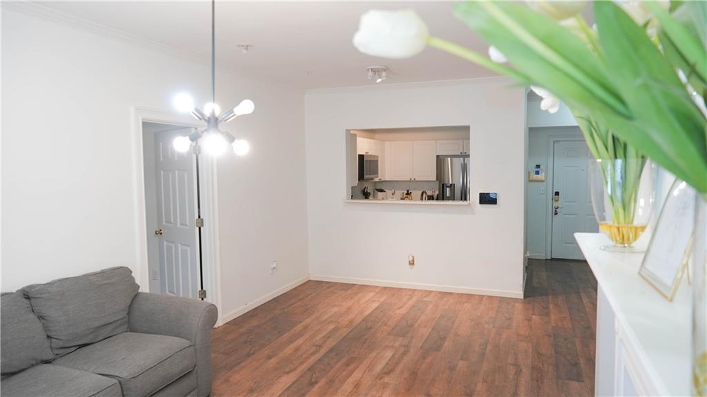 3275 Lenox Road Northeast, Unit 107 Atlanta, GA 30324 - Photo 7 of 18 a living room with furniture and a wooden floor
