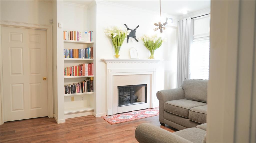 3275 Lenox Road Northeast, Unit 107 Atlanta, GA 30324 - Photo 8 of 18 a living room with furniture and a fireplace