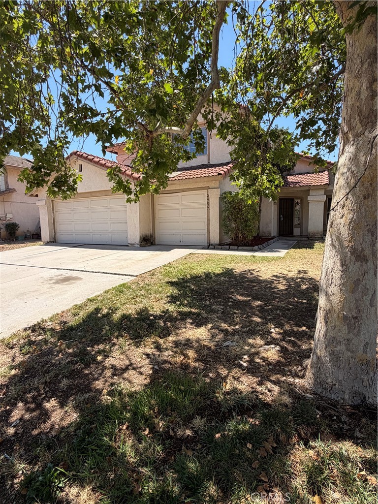 24677 Rugby Lane Moreno Valley, CA 92551 - Photo 4 of 43 Side of house - view from sidewalk. Beautiful tree in front yard.