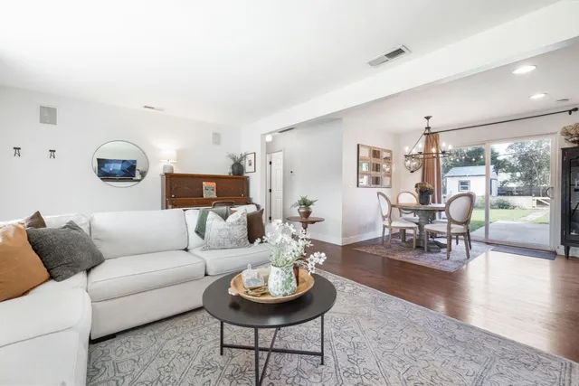 a living room with furniture and wooden floor