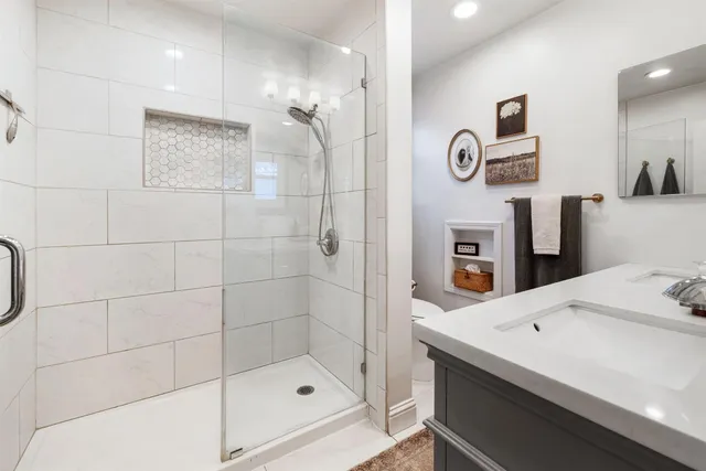 a bathroom with a sink a shower and a mirror