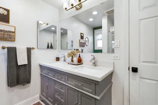 a bathroom with a sink vanity and a mirror