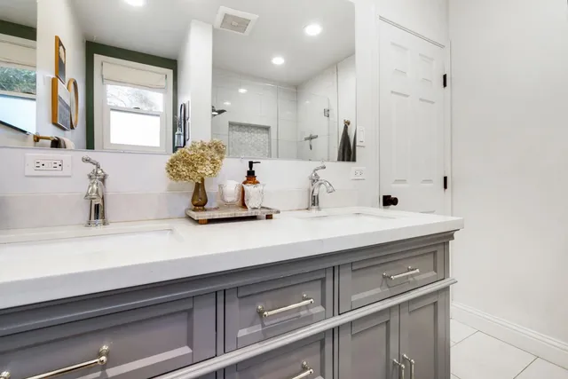 a bathroom with a sink double vanity and a mirror