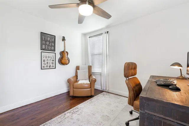 a view of workspace with wooden floor windows