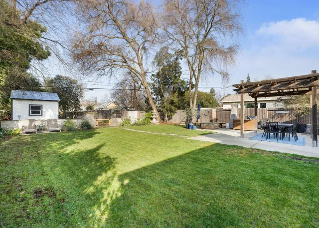 a view of a house with backyard and sitting area