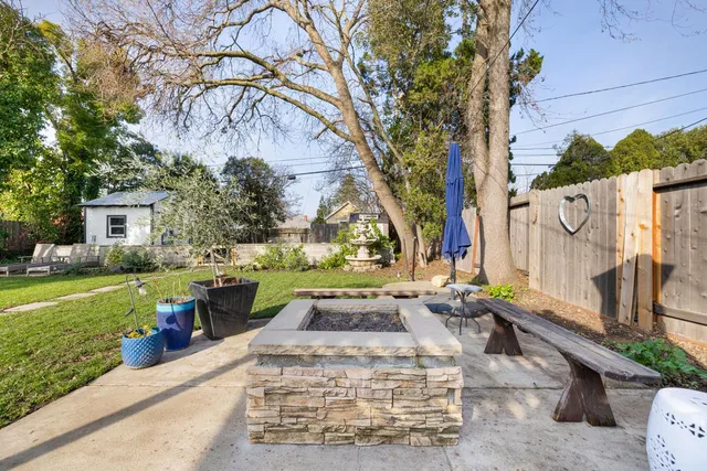 a view of a patio with table and chairs and potted plants