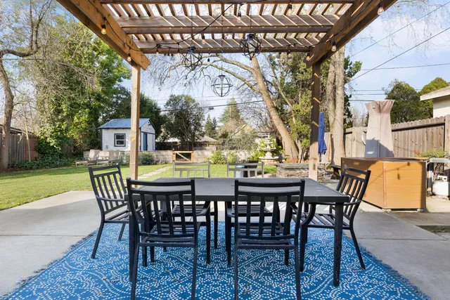 a view of a patio with a table and chairs