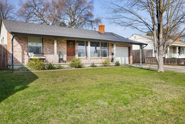 a front view of a house with a yard and porch