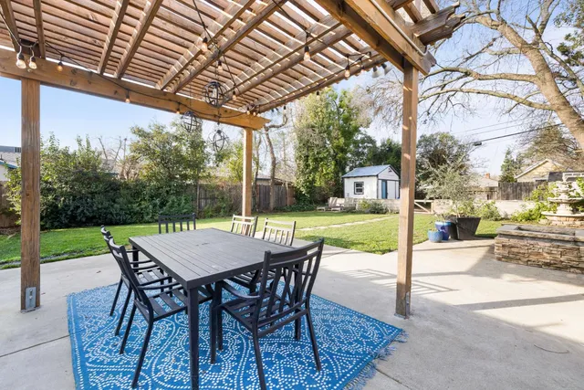 a patio with yard glass top table and chairs
