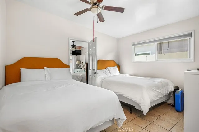a bedroom with two beds and a chandelier