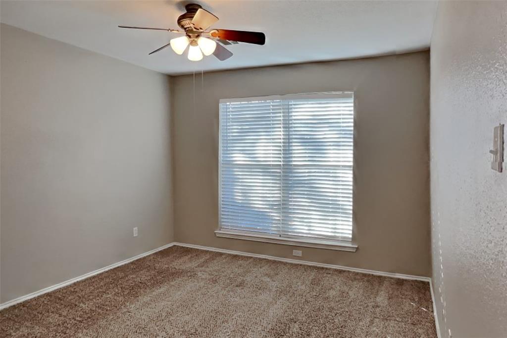 7709 Harbor Drive Rowlett, TX 75088 - Photo 13 of 19 an empty room with a window and a ceiling fan